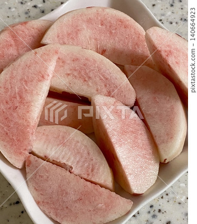 Sliced peach, showcasing its juicy, tender flesh and vibrant color. Perfect for summer recipes or fruit-related designs, this image highlights the refreshing taste and appeal of this delicious fruit. Sliced peach, showcasing its juicy, tender flesh and vibrant color. Perfect for summer recipes or fruit-related designs, this image highlights the refreshing taste and appeal of this delicious fruit. 140664923