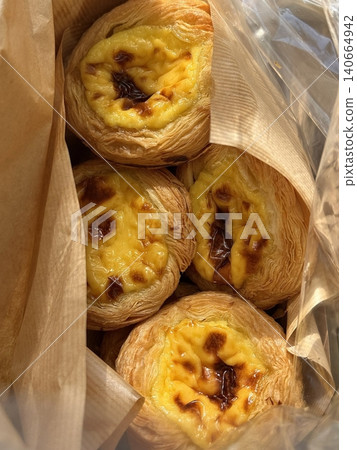 Golden egg tart with a flaky, buttery crust and a rich, creamy custard center. A deliciously satisfying treat for dessert or a light snack, blending texture and flavor perfectly. 140664942