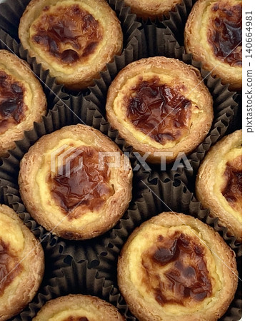 Golden egg tart with a flaky, buttery crust and a rich, creamy custard center. A deliciously satisfying treat for dessert or a light snack, blending texture and flavor perfectly. Golden egg tart with a flaky, buttery crust and a rich, creamy custard center. A deliciously satisfying treat for dessert or a light snack, blending texture and flavor perfectly. 140664981
