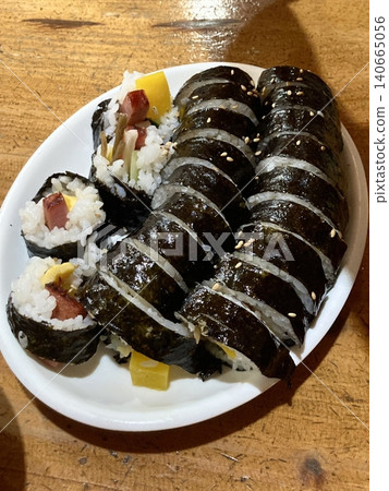 Delicious kimbap rolls filled with fresh vegetables, seasoned rice, and savory proteins, all wrapped in crisp seaweed. A perfect combination of flavor and texture in every bite. Delicious kimbap rolls filled with fresh vegetables, seasoned rice, and savory proteins, all wrapped in crisp seaweed. A perfect combination of flavor and texture in every bite. 140665056