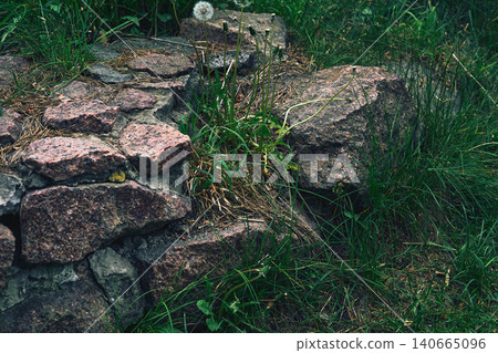 Remains of ancient granite wall made of old stones Remains of ancient granite wall made of old stones 140665096