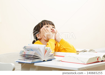 Confused Asian Girl Studying at Desk, Homework and Learning Concept Confused Asian Girl Studying at Desk, Homework and Learning Concept 140665255