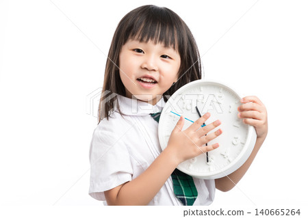 Surprised school girl holding a white clock, concept of being late or time management. Surprised school girl holding a white clock, concept of being late or time management. 140665264