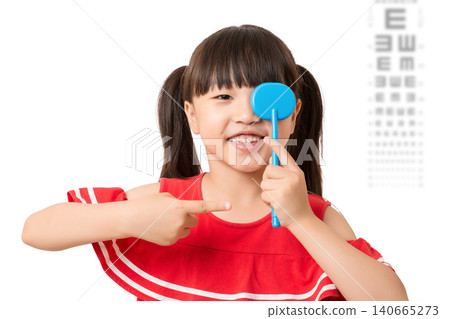 Asian little girl eye test, covering one eye, vision examination, child healthcare, ophthalmology concept Asian little girl eye test, covering one eye, vision examination, child healthcare, ophthalmology concept 140665273