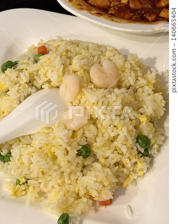 nasi goreng or fried rice traditional frying rice dish from indonesia made of Precooked rice fried in a small amount of oil, then spiced up with shallots, garlic, chili and sweet soy sauce. 140665404