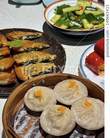 Shumai shrimp with sauce, Steamed shrimp dumplings dim or dim sum and vegetable on wooden table, Cantonese Dimsum food cuisine for breakfast, Chinese traditional food. Shumai shrimp with sauce, Steamed shrimp dumplings dim or dim sum and vegetable on wooden table, Cantonese Dimsum food cuisine for breakfast, Chinese traditional food. 140665415