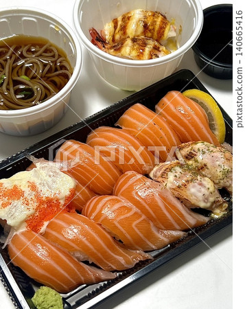 Fresh salmon sushi with bright orange slices placed on top of perfectly shaped rice, garnished with green leaves and radish for a simple, colorful, and appetizing presentation Fresh salmon sushi with bright orange slices placed on top of perfectly shaped rice, garnished with green leaves and radish for a simple, colorful, and appetizing presentation 140665416