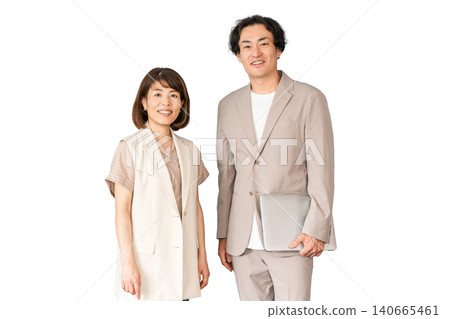 Male and female business people standing with laptops in the office Male and female business people standing with laptops in the office 140665461