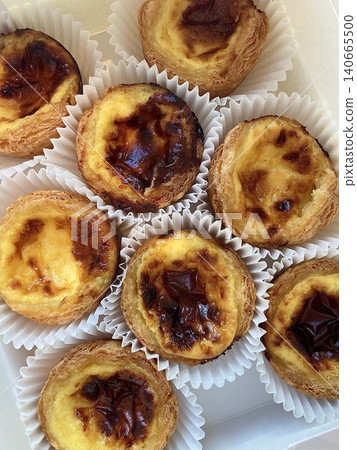 Golden egg tart with a flaky, buttery crust and a rich, creamy custard center. A deliciously satisfying treat for dessert or a light snack, blending texture and flavor perfectly. 140665500