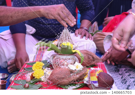 Performing Kalash puja rituals in Indian traditional wedding ceremony Performing Kalash puja rituals in Indian traditional wedding ceremony 140665703