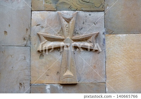 This carved stone relief is consistent with a Maltese cross. This carved stone relief is consistent with a Maltese cross. 140665766