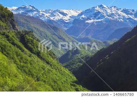 Majestic mountains rise under clear blue skies Majestic mountains rise under clear blue skies 140665780