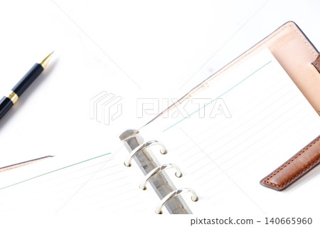 Image of a ring-type system organizer open while doing desk work Image of a ring-type system organizer open while doing desk work 140665960
