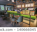 Modern coffee shop interior featuring a vibrant illuminated green service counter, stylish wooden bar. 140666045