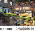 Modern coffee shop interior featuring a vibrant illuminated green service counter, stylish wooden bar. 140666049