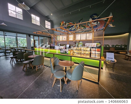 Modern coffee shop interior featuring a vibrant illuminated green service counter, stylish wooden bar. Modern coffee shop interior featuring a vibrant illuminated green service counter, stylish wooden bar. 140666063