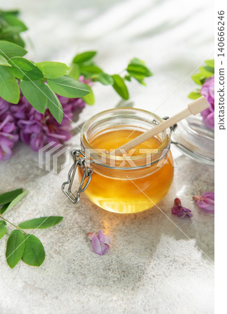 Natural acacia honey in a jar with flowers Natural acacia honey in a jar with flowers 140666246