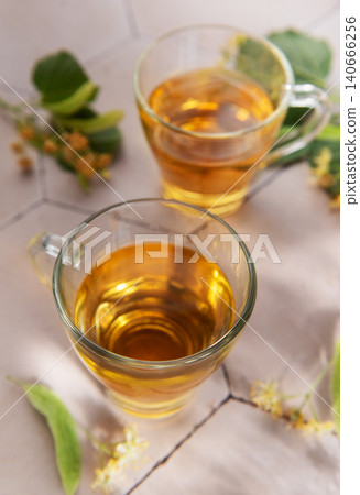 Linden herbal tea in clear cups with lime blossoms 140666256