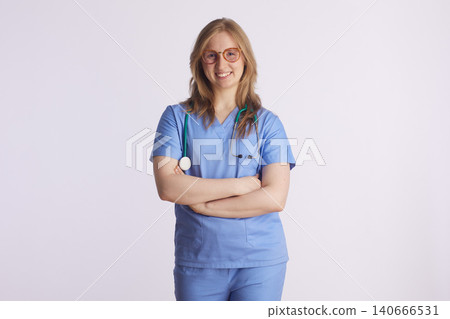 Confident Female Nurse in Blue Scrubs with Glasses Confident Female Nurse in Blue Scrubs with Glasses 140666531