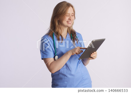 Smiling Nurse Interacting with Digital Tablet 140666533