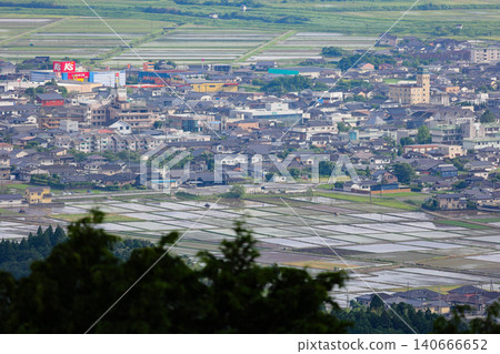 A view from Takakuma Mountain, the site of fierce fighting during the Satsuma Rebellion, showing the rice paddies and townscape of the Isa City Basin during the rice planting season. A view from Takakuma Mountain, the site of fierce fighting during the Satsuma Rebellion, showing the rice paddies and townscape of the Isa City Basin during the rice planting season. 140666652