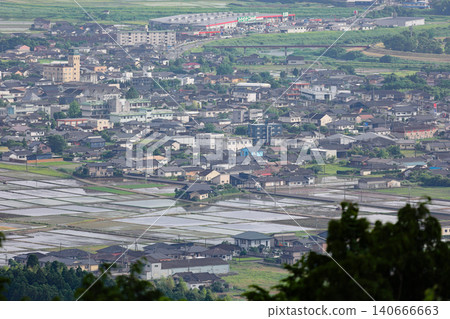 A view from Takakuma Mountain, the site of fierce fighting during the Satsuma Rebellion, showing the rice paddies and townscape of the Isa City Basin during the rice planting season. A view from Takakuma Mountain, the site of fierce fighting during the Satsuma Rebellion, showing the rice paddies and townscape of the Isa City Basin during the rice planting season. 140666663