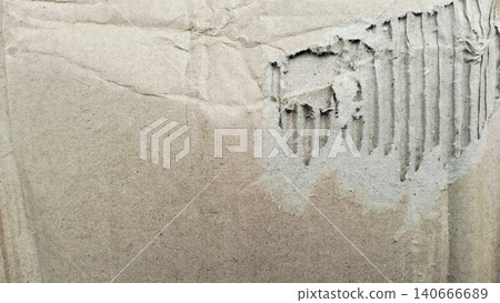 Close-up of damaged brown kraft paperboard, rustic grunge corrugated material. Close-up of damaged brown kraft paperboard, rustic grunge corrugated material. 140666689