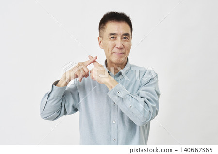 A man making an "X" gesture against a white background. 140667365