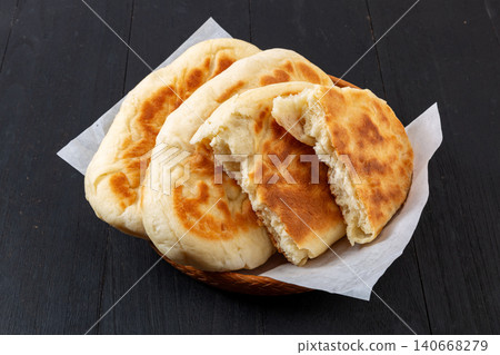 traditional Chinese Guokuei Flatbread Served on a Wooden Plate. Crispy Baked Shanjian Pancake, Asian Street Food Snack. 140668279