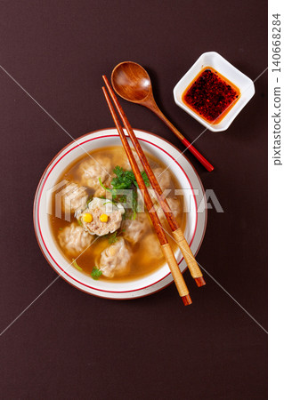 chinese Wonton Soup with Sweet Corn and Pork Stuffing. Hot Asian Dumpling Soup with Cilantro, Comfort Noodle Alternative. 140668284