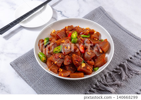 stir-fried Chinese starch jelly with savory donkey meat and green chili peppers in a white bowl, Hebei local specialty stir-fried Chinese starch jelly with savory donkey meat and green chili peppers in a white bowl, Hebei local specialty 140668299