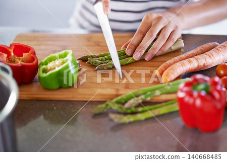 Chopping, healthy and cooking in home kitchen, organic food or meal prep with fresh produce. Diet, nutrition and cutting board for wellness ingredient, pepper asparagus or carrot in vegan lunch snack Chopping, healthy and cooking in home kitchen, organic food or meal prep with fresh produce. Diet, nutrition and cutting board for wellness ingredient, pepper asparagus or carrot in vegan lunch snack 140668485