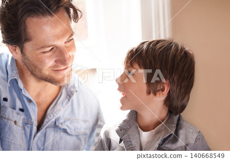 Dad, boy and smile conversation in home, happy son and man bonding for child development and paternal relationship. Kid, family vacation house and male person listening or discussion on Fathers day Dad, boy and smile conversation in home, happy son and man bonding for child development and paternal relationship. Kid, family vacation house and male person listening or discussion on Fathers day 140668549