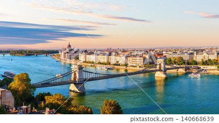Budapest panorama view of Hungarian Parliament Building and Chain Bridge over Danube River at sunset, Hungary Budapest panorama view of Hungarian Parliament Building and Chain Bridge over Danube River at sunset, Hungary 140668639