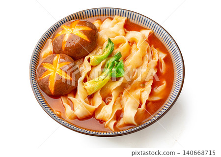 Chinese traditional knife-cut noodles in rich tomato soup with shiitake mushrooms on a wooden tray. Chinese traditional knife-cut noodles in rich tomato soup with shiitake mushrooms on a wooden tray. 140668715