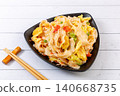 Stir-fried Chinese knife-cut noodles with fresh tomatoes, scrambled eggs, and green onions 140668735