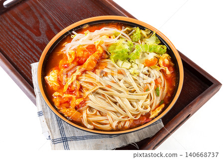 Nutritious mung bean noodles in a rich tomato and egg soup, garnished with fresh cilantro Nutritious mung bean noodles in a rich tomato and egg soup, garnished with fresh cilantro 140668737