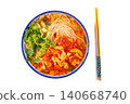 Classic Chinese tomato and egg noodle soup garnished with fresh green vegetables in a blue ceramic bowl 140668740