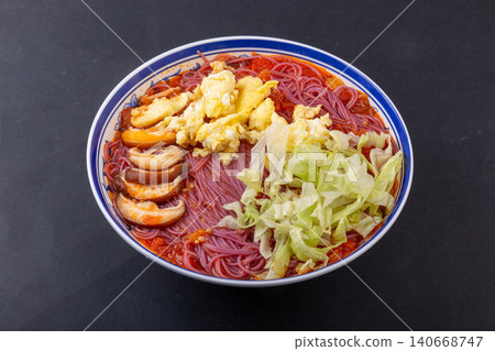 Vibrant purple sweet potato noodles served in a rich tomato sauce, topped with eggs and fresh lettuce Vibrant purple sweet potato noodles served in a rich tomato sauce, topped with eggs and fresh lettuce 140668747