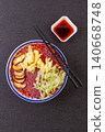 Vibrant purple sweet potato noodles served in a rich tomato sauce, topped with eggs and fresh lettuce 140668748