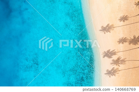 Aerial turquoise lagoon panoramic palm shadows. Powdery white sand meets crystal shallows from above. Wide drone vista tropical paradise, peaceful summer travel banner Aerial turquoise lagoon panoramic palm shadows. Powdery white sand meets crystal shallows from above. Wide drone vista tropical paradise, peaceful summer travel banner 140668769