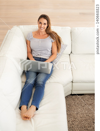 Portrait, woman or computer on sofa as writing, blog or ebook on internet, news or social network. Smile, female person or laptop as reading, online communication or email as digital download 140668823