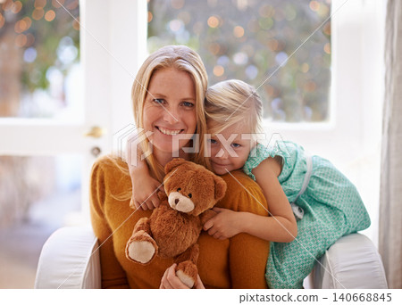 Happy mama, portrait and hug with child or teddy bear for love, care or support together in living room at home. Face of mom, kid or daughter with smile for embrace, affection or mothers day at house Happy mama, portrait and hug with child or teddy bear for love, care or support together in living room at home. Face of mom, kid or daughter with smile for embrace, affection or mothers day at house 140668845