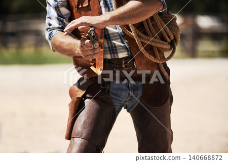 Cowboy, confrontation and aim gun to shoot for standoff or gunfight in duel for wild western culture in Texas. Male gunslinger or outlaw, revolver and tough for defense or conflict with closeup Cowboy, confrontation and aim gun to shoot for standoff or gunfight in duel for wild western culture in Texas. Male gunslinger or outlaw, revolver and tough for defense or conflict with closeup 140668872