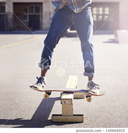 Skatepark, balance and man with riding skateboard for technique, skill and trick in recreation activity. Skateboarder, lens flare and male person for training, competition or hobby in city of Atlanta Skatepark, balance and man with riding skateboard for technique, skill and trick in recreation activity. Skateboarder, lens flare and male person for training, competition or hobby in city of Atlanta 140668920