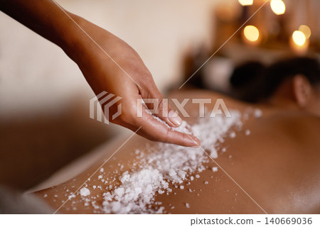 Hand, massage and salt with woman at spa on bed or table for luxury pamper treatment closeup. Relax, wellness and back of customer at beauty resort or salon for holistic therapy or exfoliation Hand, massage and salt with woman at spa on bed or table for luxury pamper treatment closeup. Relax, wellness and back of customer at beauty resort or salon for holistic therapy or exfoliation 140669036