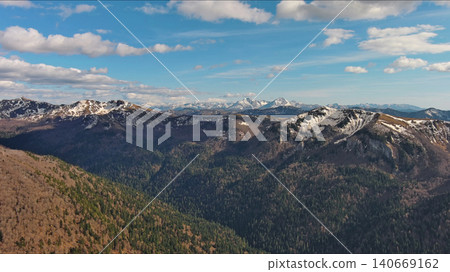 Snow capped mountains under blue sky in spring Snow capped mountains under blue sky in spring 140669162