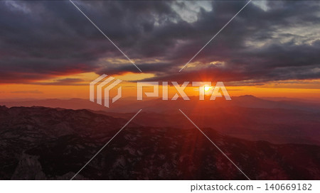 Sunset over mountain with dramatic clouds Sunset over mountain with dramatic clouds 140669182