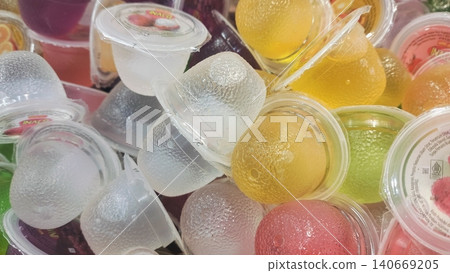 Multi-flavored small gelatin jelly cups background at a grocery store. Multi-flavored small gelatin jelly cups background at a grocery store. 140669205