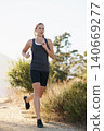 Athlete, woman and running on trail with fitness for sport, training or exercise for competition on mountain. Marathon, person or runner with wellness, challenge or cardio for healthy body in Denmark 140669277